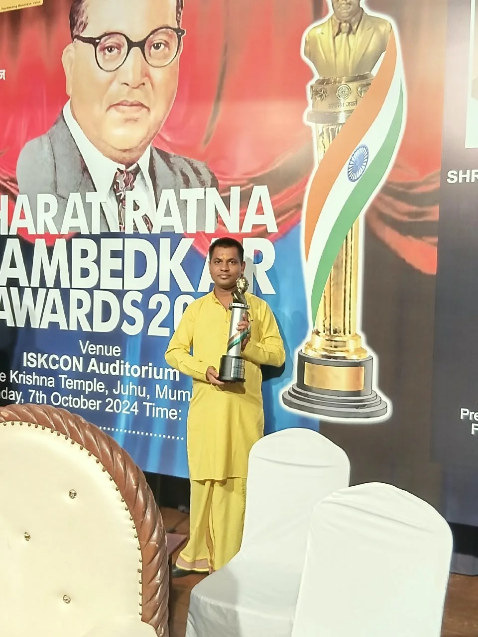Dr. Shastri holding a trophy at an awards event